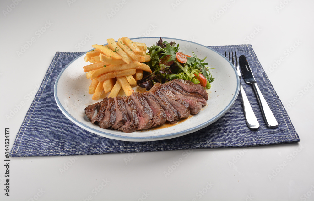 bbq grilled juicy wagyu beef tenderloin sirloin steak in brown black pepper sauce with French fries and vegetables salad dressing western cuisine menu bbq grilled juicy wagyu beef tenderloin sirloin steak in brown black pepper sauce with French fries and vegetables salad dressing western cuisine menu