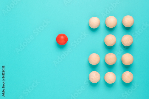 Картината върху платно A wooden red ball be apart from the group of the similar balls, individual or di