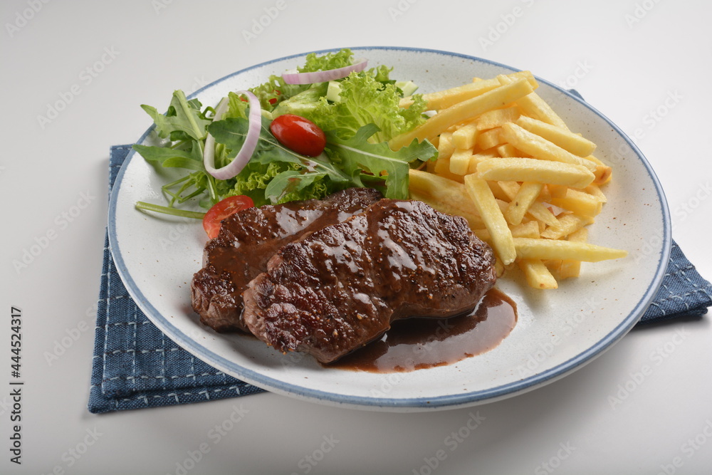 chef bbq grilled juicy wagyu beef tenderloin sirloin steak in brown black pepper sauce with French fries and vegetables salad dressing hotel fine dining western restaurant cafe halal cuisine menu chef bbq grilled juicy wagyu beef tenderloin sirloin steak in brown black pepper sauce with French fries and vegetables salad dressing hotel fine dining western restaurant cafe halal cuisine menu