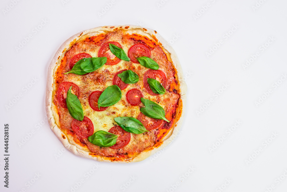 freshly baked Italian pizza with cheese and tomato sauce, garnished with basil leaves. Ingredients. view from above freshly baked Italian pizza with cheese and tomato sauce, garnished with basil leaves. Ingredients. view from above
