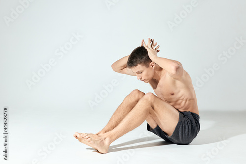 athlete doing push-ups indoors and hands behind the head fitness pumped up torso