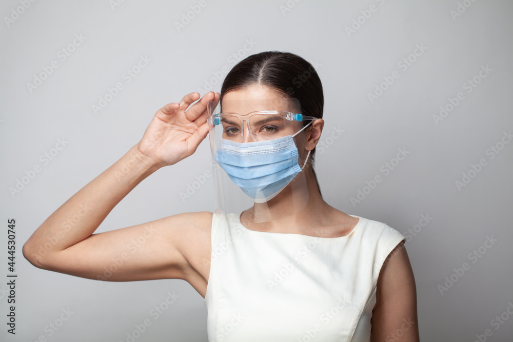Young female wearing a face shield with mask. Coronavirus pandemic. Young female wearing a face shield with mask. Coronavirus pandemic.