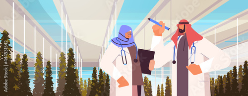 arab agricultural engineers researching plants and writing results in tablet smart farm agriculture scientist concept