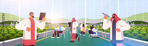 arabic agricultural engineers researching plants in greenhouse agriculture scientist smart farming concept