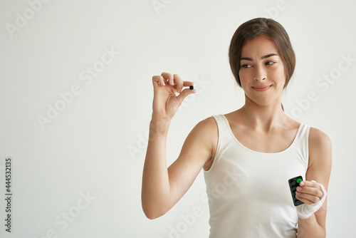 woman with pills in hands in white t-shirt injured hand health medicine