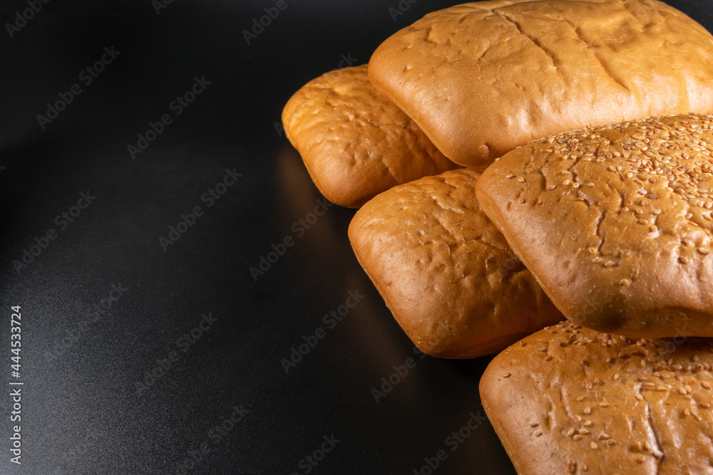 panini bun, sandwich. Without ingredients, on a black background. Bakery production concept.