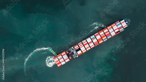 tug ship drag container cargo smart ship vessel to cargo international container yard port concept shipping by sea.