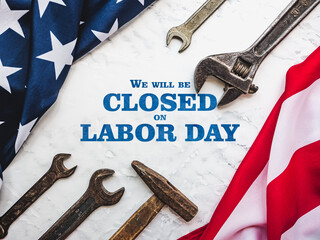 LABOR DAY. Hand tools and the Flag of the United States of America lying on the table. View from above, close-up. Congratulations to family, relatives, friends and colleagues. National holiday concept
