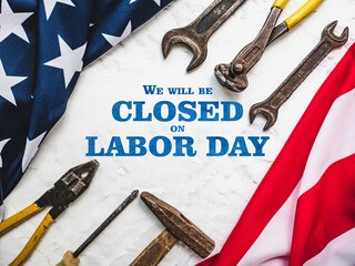 LABOR DAY. Hand tools and the Flag of the United States of America lying on the table. View from above, close-up. Congratulations to family, relatives, friends and colleagues. National holiday concept