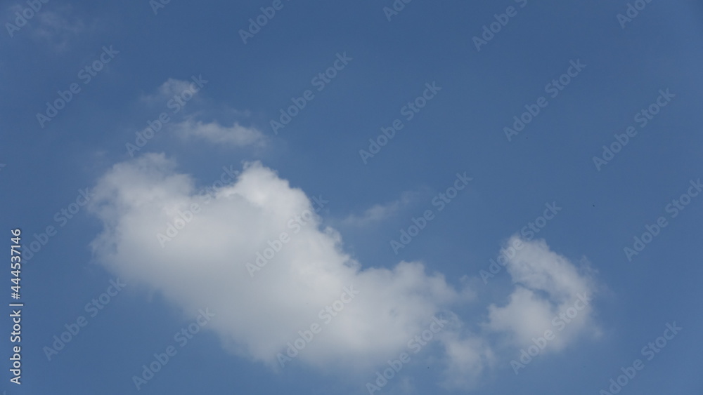 Clouds in the shape of a praying baby against clear blue sky