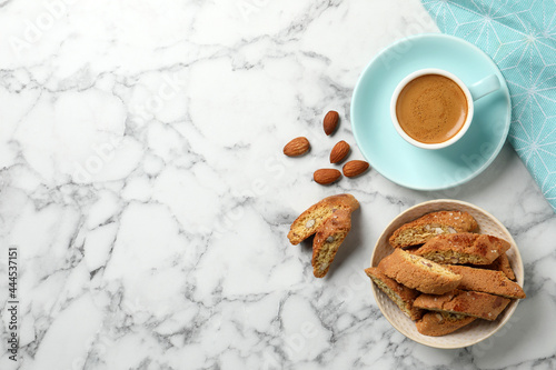 Photos Flat lay composition with tasty cantucci and aromatic coffee on white marble table, space for text