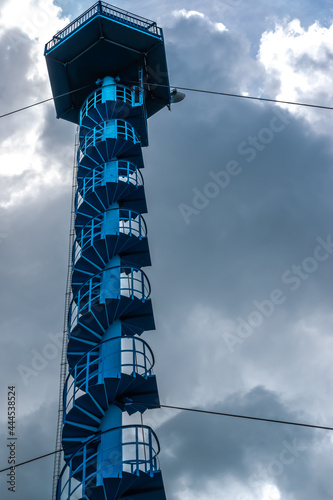 High fire watchtower in the forest. Photo taken on a cloudy day with natural light. photo