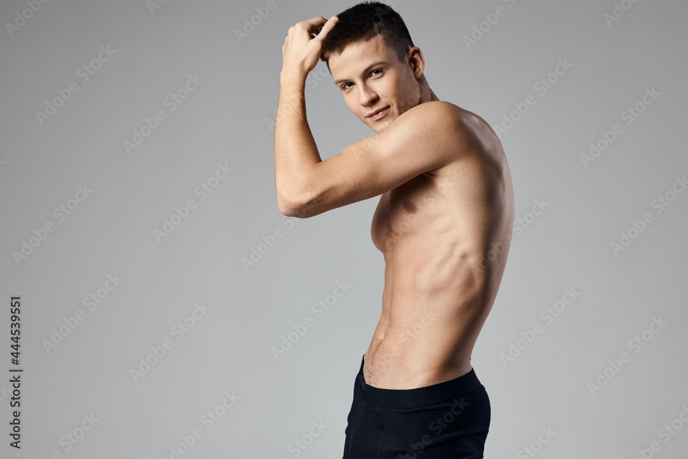athlete with naked torso showing arm muscles on gray background cropped view of bodybuilder fitness athlete with naked torso showing arm muscles on gray background cropped view of bodybuilder fitness