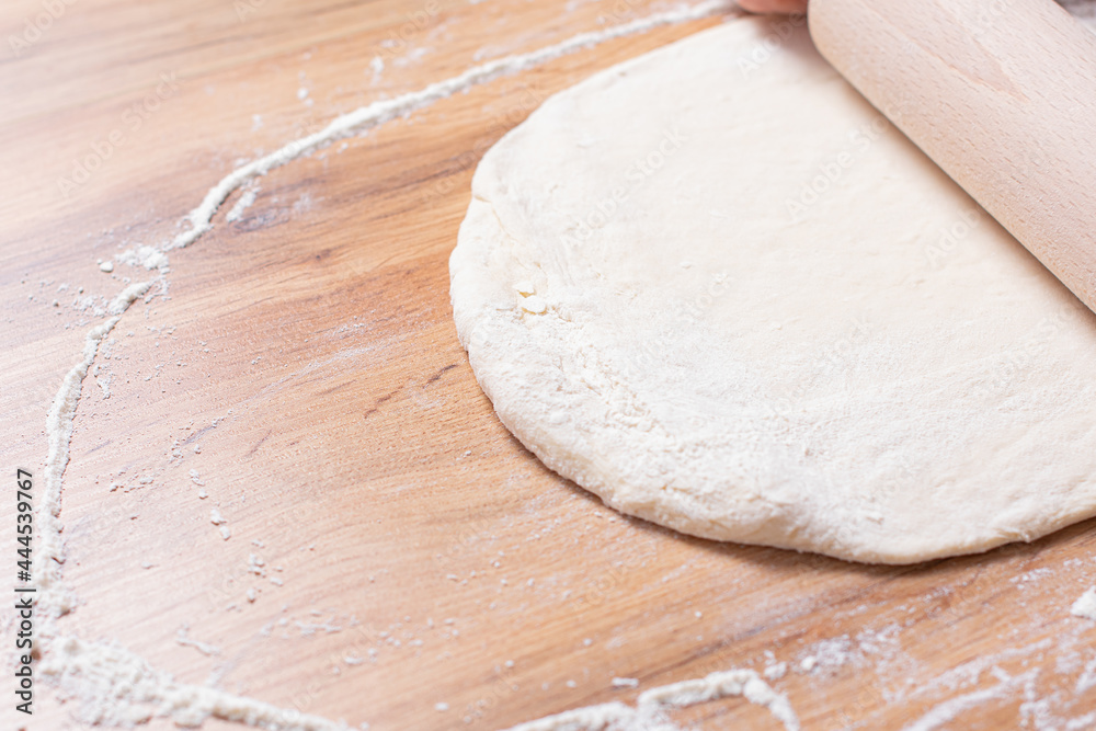 Rolling pin and dough. Woman preparing dough Rolling pin and dough. Woman preparing dough
