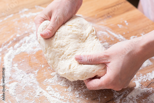 Rolling pin and dough. Woman preparing dough