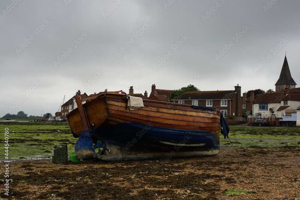 boat on shore overlooking village boat on shore overlooking village