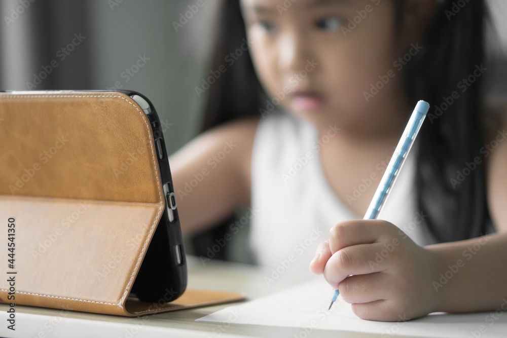 asian child student back to school or kid girl e-learning write note or draw by pencil and read on computer tablet to doing homework education or people learn from home study online on smartphone pad asian child student back to school or kid girl e-learning write note or draw by pencil and read on computer tablet to doing homework education or people learn from home study online on smartphone pad