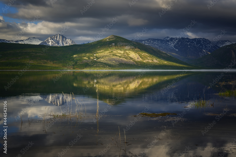 Mirror image on a mountain lake on a spring morning