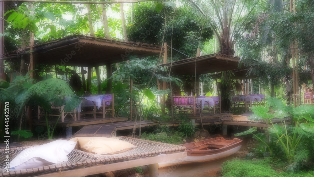 June 30 2021, Ranong, Thailand : Blurred view in nature with relax seat and creek of cafe and restaurant at Baan Rai Irun, Ranong, Thailand. June 30 2021, Ranong, Thailand : Blurred view in nature with relax seat and creek of cafe and restaurant at Baan Rai Irun, Ranong, Thailand.