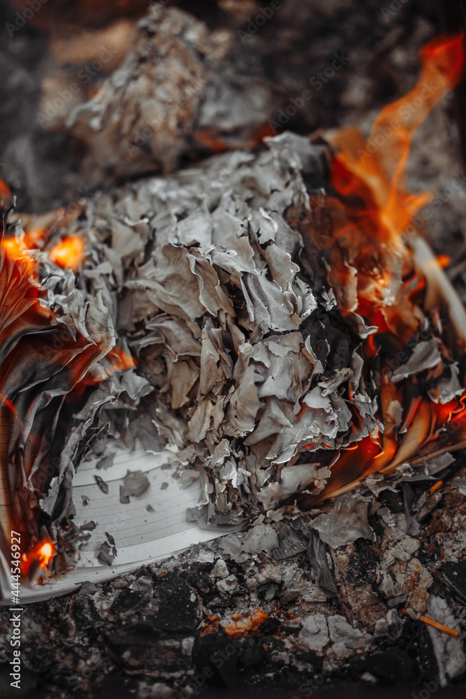 The paper burns in the fire turns into ashes. Burnt pages. Charred and scorched paper.  Burnt memories.