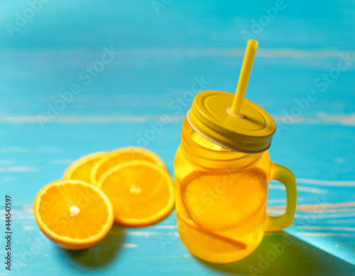 Cold drink with oranges in jar photo