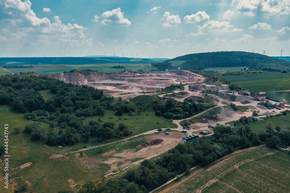 Obraz premium View from above of a gravel plant in the middle of a forest area in Rhineland-Palatinate / Germany 
