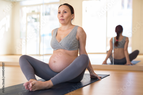 Pregnant woman is engaged in yoga. Butterfly Pose or Baddha Konasana