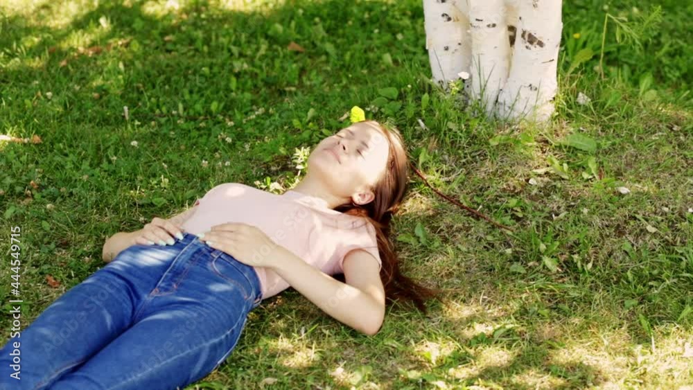 summer vacation, happy teenager is lying on the grass, smiling, laughing summer vacation, happy teenager is lying on the grass, smiling, laughing