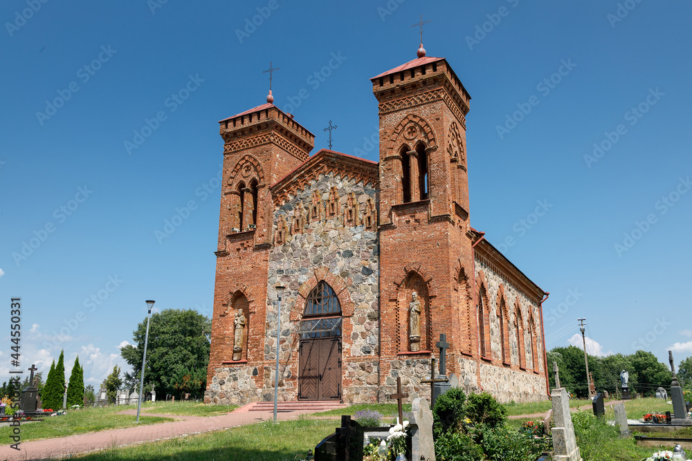 Side view of rectangular plan, two-tower church with Neo-Gothic features of the Romantic period fence stone masonry