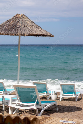 Blue beach chairs and umbrella on the beach