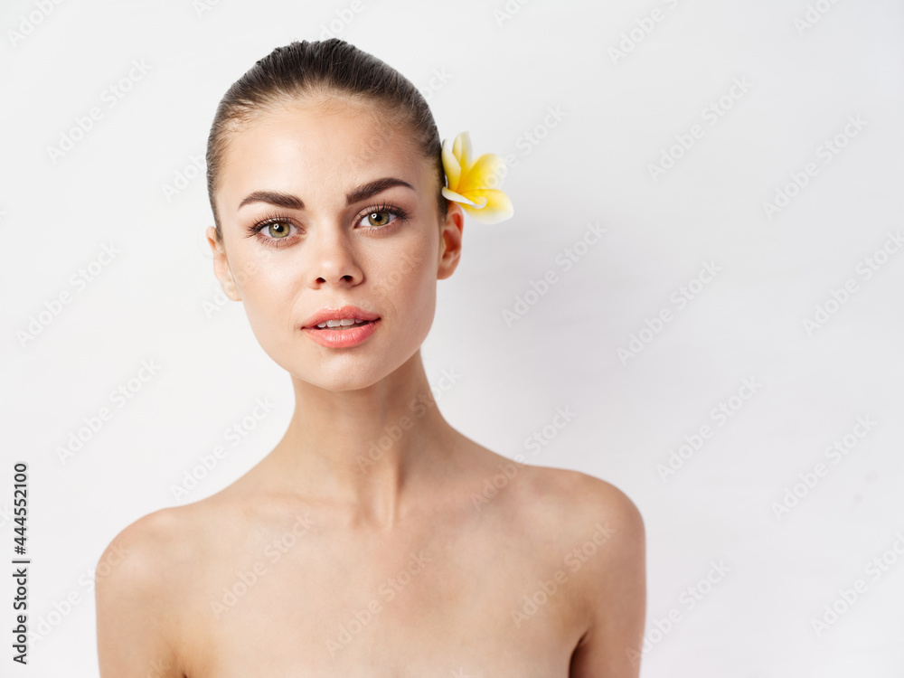 woman naked shoulders attractive look yellow flower in hair cropped view woman naked shoulders attractive look yellow flower in hair cropped view