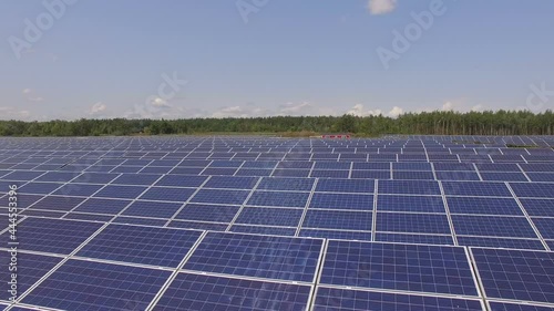 Aerial footage of hundreds solar energy modules or panels rows