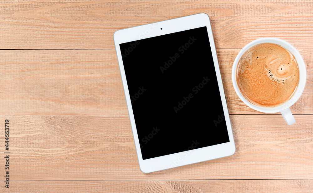 digital tablet with copy space and coffee mug on wooden table digital tablet with copy space and coffee mug on wooden table