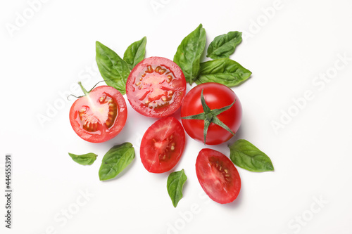 Fresh basil leaves and tomatoes on white background, flat lay