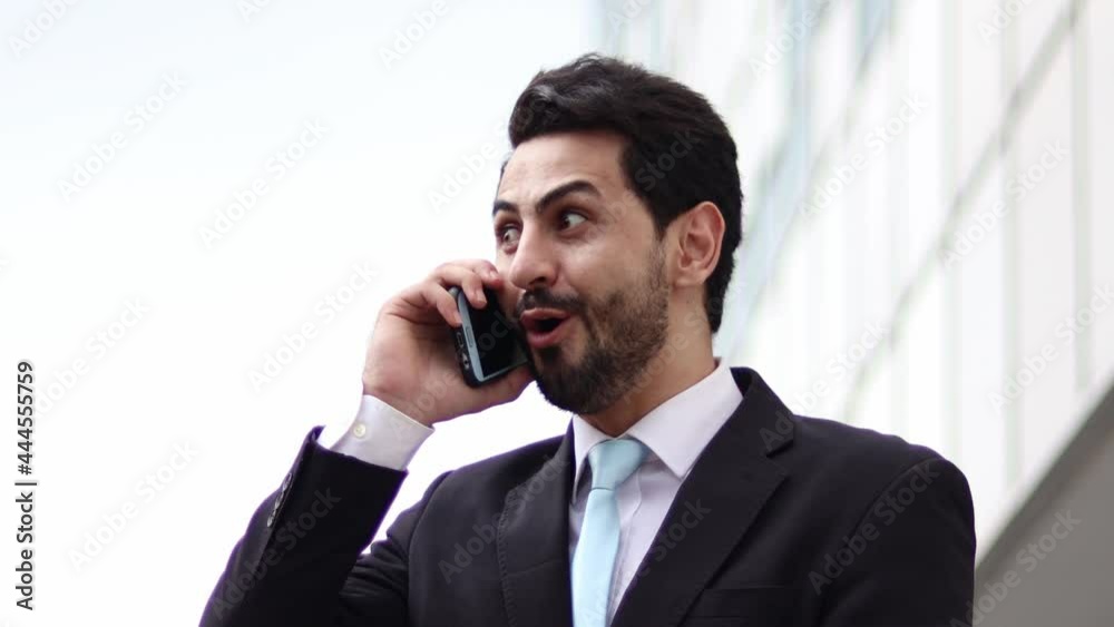 Happily, surprised businessman enjoys success or good news, or mobile online bet bid game, or prize in the lottery on smartphone at home. Funny lucky joyful winner. Happily, surprised businessman enjoys success or good news, or mobile online bet bid game, or prize in the lottery on smartphone at home. Funny lucky joyful winner.