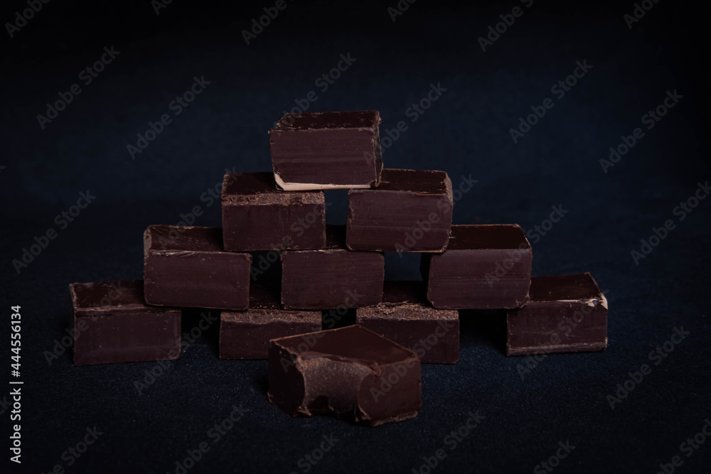 dark dark chocolate cubes on a black background
