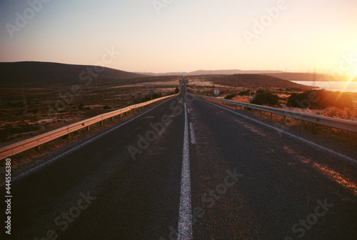 Empty country road background on sunset.