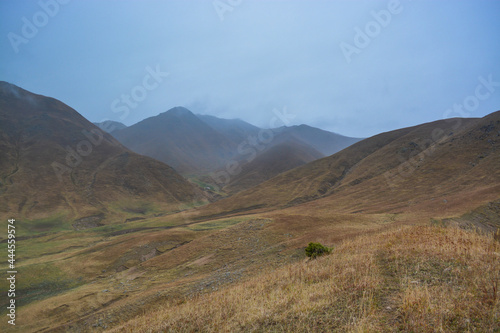 Mountains in the fog. Fall. Overcast. Ile-Alatau mountains, Almaty region, Kazakhstan.