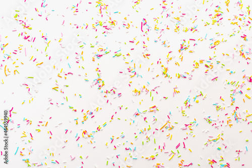 Confectionery sprinkles on a white background. Sprinkle for Easter cake. Colored background.