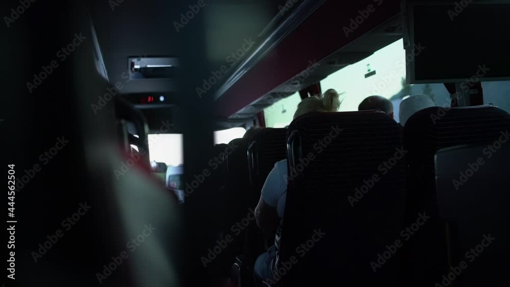 Tourist passengers seated inside bus cabin during travel rear view Tourist passengers seated inside bus cabin during travel rear view