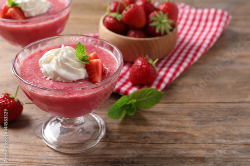Delicious strawberry mousse with mint on wooden table, space for text