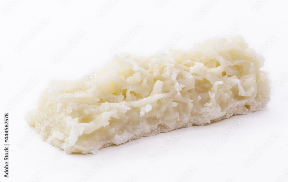 typical Brazilian sweet, called cocada, made at home. Isolated white background with copy space