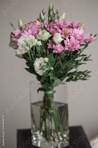 Beautiful bouquet of spring flowers. Delicate bouquet of pink and white flowers. Pink peony roses  purple chrysanthemum  white roses. Spring colors on grey background.