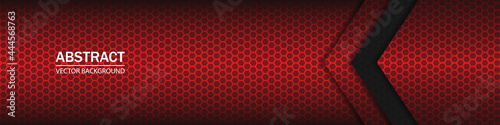 Abstract geometric arrow shapes on a hexagonal red grid. Black and red shapes, stripes and lines on a dark hexagonal carbon fiber background.