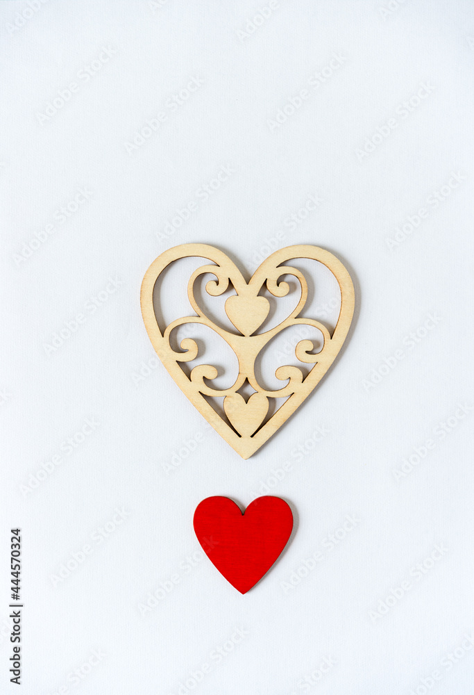 fancy laser cut heart and plain hand painted red heart on a light background fancy laser cut heart and plain hand painted red heart on a light background