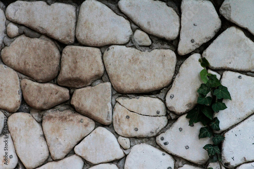 Wall cladding made using white, rounded white stones
