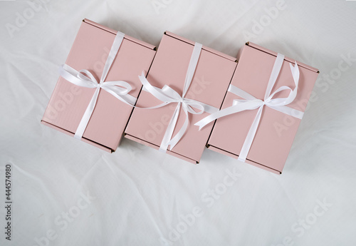 One gift wrapped in pink paper with an elegant white bow. for someone special.