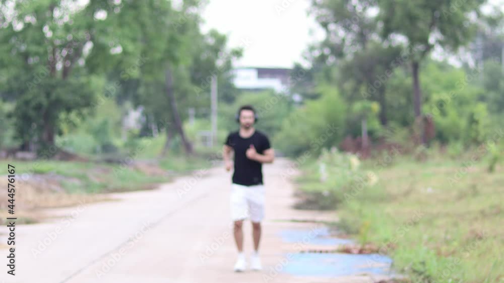 Happy handsome man with headphones to relax in the natural background. Happy handsome man with headphones to relax in the natural background.