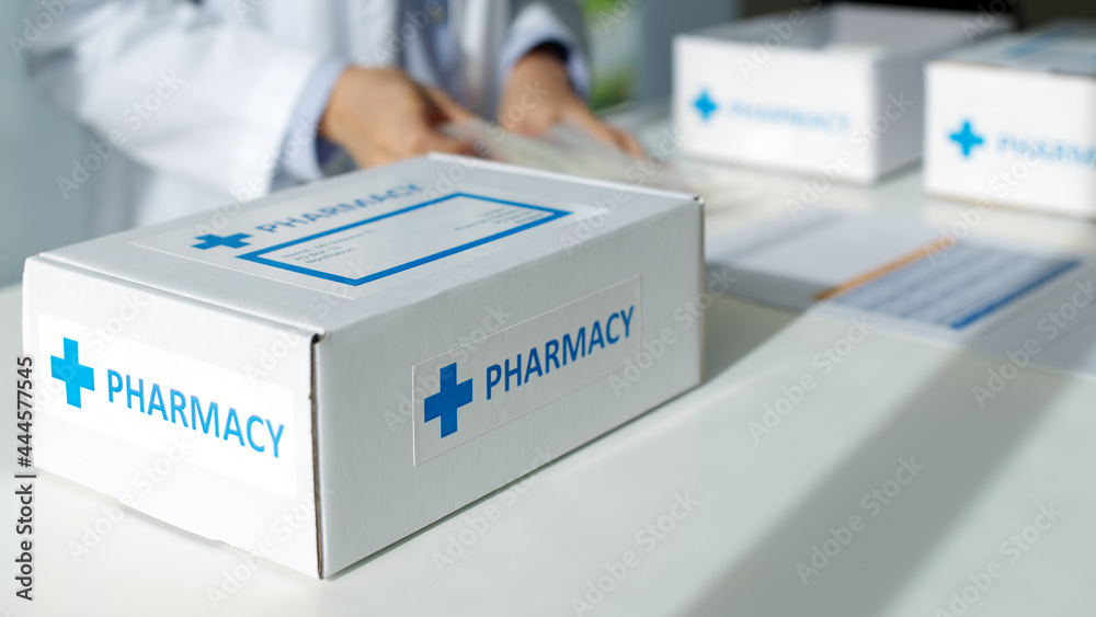 Close-up hand asia woman chemist help pack covid free first aid self recover care on desk give for customer people buy online clinic retail Rx drug store in telehealth telemedicine e-commerce order. Close-up hand asia woman chemist help pack covid free first aid self recover care on desk give for customer people buy online clinic retail Rx drug store in telehealth telemedicine e-commerce order.