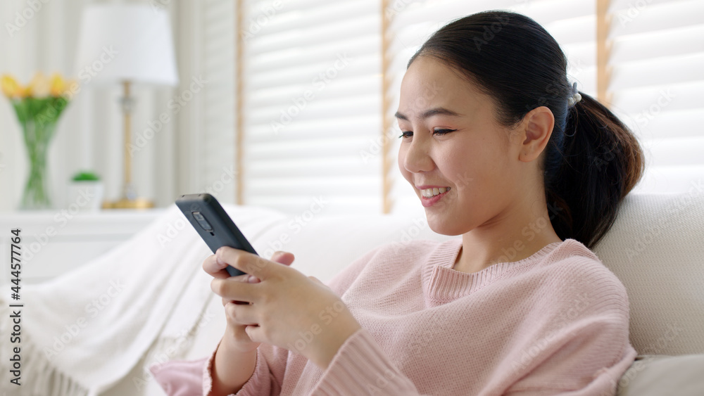 Young asia people 5G wifi digital device user teen girl watch read news play social media, e-commerce iot data app, pay money, remote shop retail store at home sofa couch sit easy relax happy smile. Young asia people 5G wifi digital device user teen girl watch read news play social media, e-commerce iot data app, pay money, remote shop retail store at home sofa couch sit easy relax happy smile.